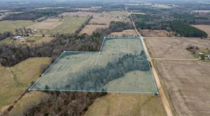 Aerial view of rural land parcel outlined in blue for sale